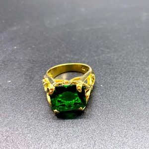 Ornate Gold Colored ring with emerald style gem